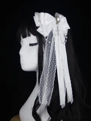 Elegant white lolita headdress featuring lace tassels with pearl chain pendants displayed on mannequin with black curly wig, pure side profile