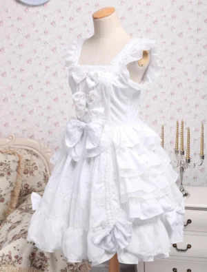 White lolita jumper skirt dress three-quarter front view showing cutout shoulder details ruffled trim and multiple layered ruffled skirt tiers