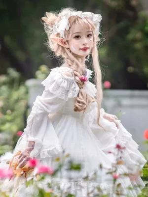 White Lolita dress with long sleeves and lace ruffled collar detail, three-quarter side view of model with braided hair in outdoor flower garden aesthetic