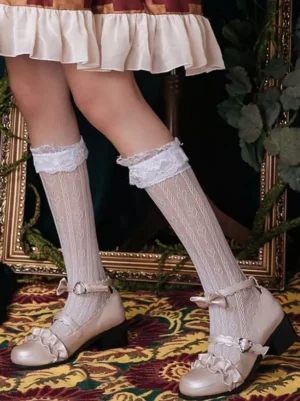 White lolita lace ruffle calf socks front view paired with ruffled skirt and bow-decorated mary jane shoes showcasing sheer mesh knit texture and frilled lace cuff
