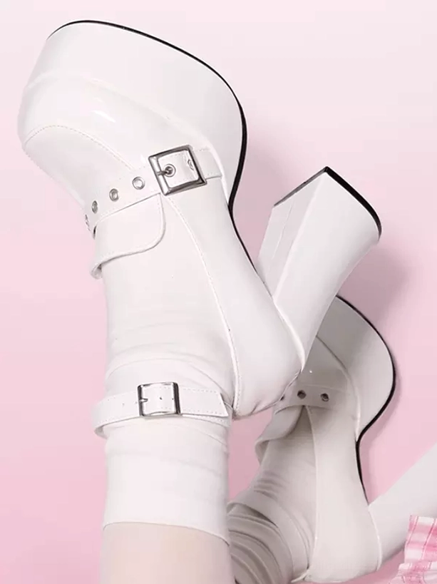White patent leather lolita mary jane platform shoes with stud vamp decorations and dual buckle straps, top-down close-up showing thick platform and glossy PU upper