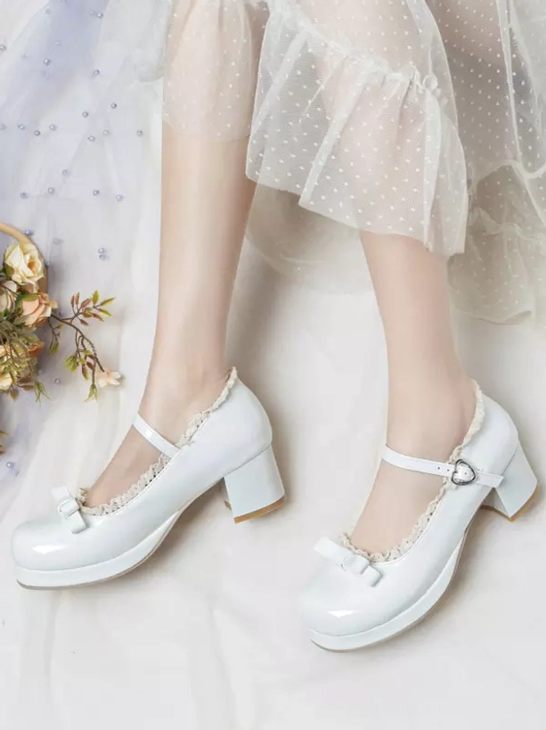 White lolita mary jane pumps side low-angle view worn feet model wearing polka dot tulle skirt ankle strap buckle ruffled edge chunky heel