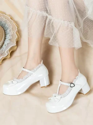 White sweet lolita Mary Jane platform pumps with T-strap and bow accent, side view worn with dotted sheer tulle skirt showing lace trim and block heel