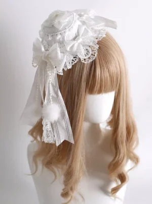 white sweet lolita mini hat headpiece with lace bows and fluffy pom-pom pendant left side view on mannequin