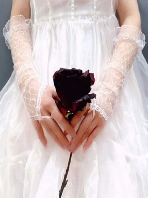 Long lace bridal oversleeves straight front view on model in white formal dress holding dark red rose showing honeycomb mesh texture and ruffled cuff edges