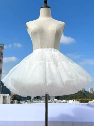 White lolita petticoat front view displayed on dress form mannequin showing structured tulle crinoline silhouette with dramatic bell-shaped volume and layered sheer material against urban rooftop background