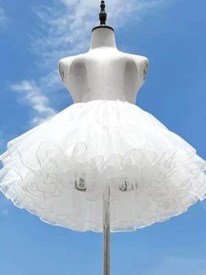 White lolita tulle petticoat underskirt front view on mannequin displaying 4-layer unboned structure with fluffy ruffled hem outdoor sunny setting