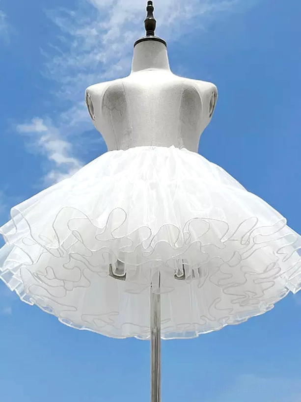 White lolita tulle petticoat underskirt front view on mannequin displaying 4-layer unboned structure with fluffy ruffled hem outdoor sunny setting