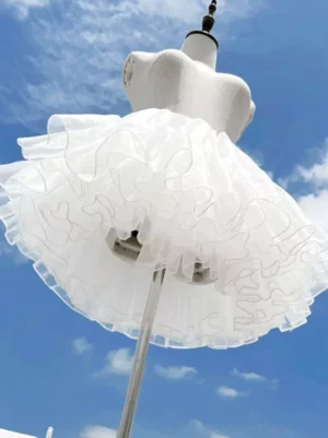 White lolita petticoat rear back view low angle showing full layered tulle silhouette and fluffed ruffled skirt edge on mannequin