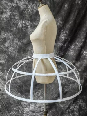 Side profile view of white metal cage crinoline petticoat showing multi-layered hoops vertical support bars and overall silhouette structure for authentic lolita fashion