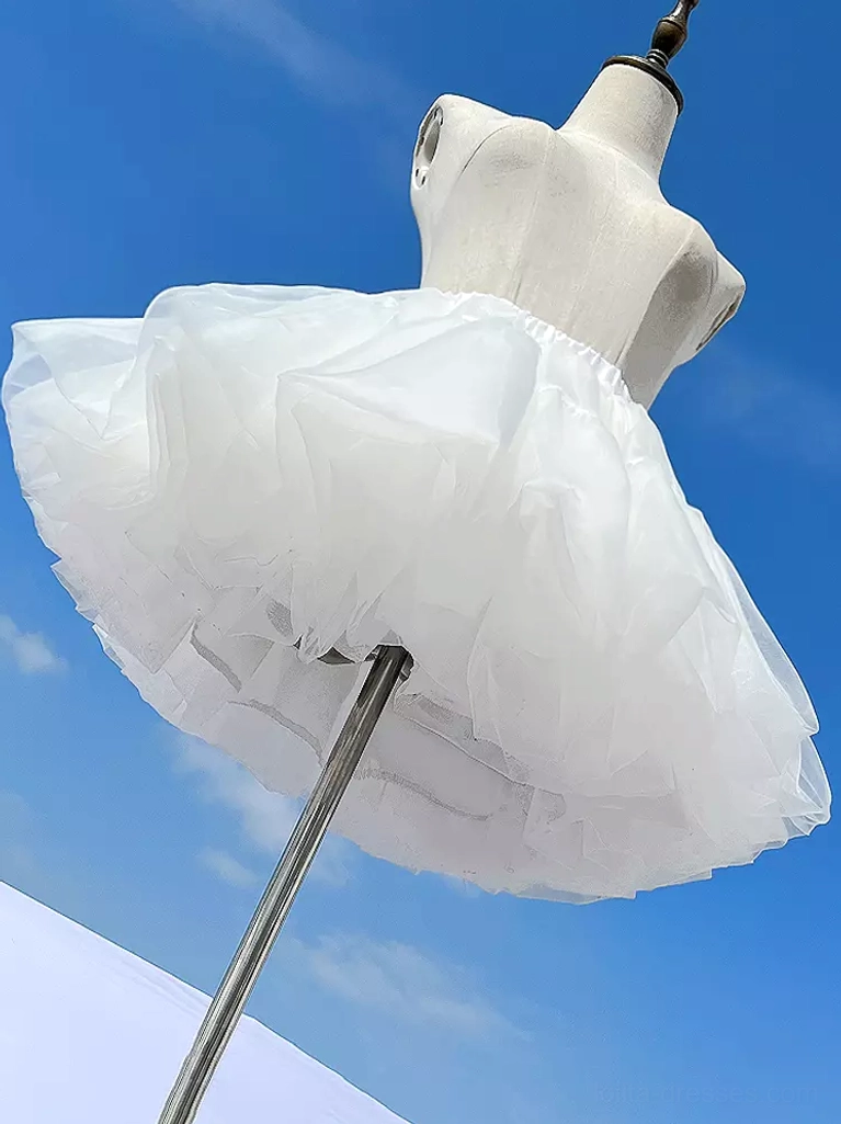 White lolita petticoat side angle view on mannequin displaying fluffy voluminous silhouette with multi-layer sheer tulle construction and elastic waistband detail against blue sky outdoor background