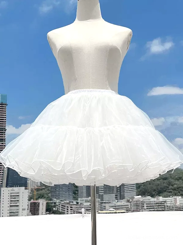 White lolita tulle petticoat front view on mannequin with plain pleated tulle hem detail urban city background