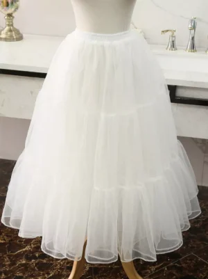 White lolita petticoat front quarter view displaying flared tiered silhouette with soft ruffled edges and sheer mesh construction