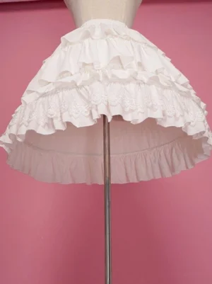 White Lolita petticoat side low angle view displaying multi-layered ruffle construction and sheer mesh fabric with embroidered lace hem trim