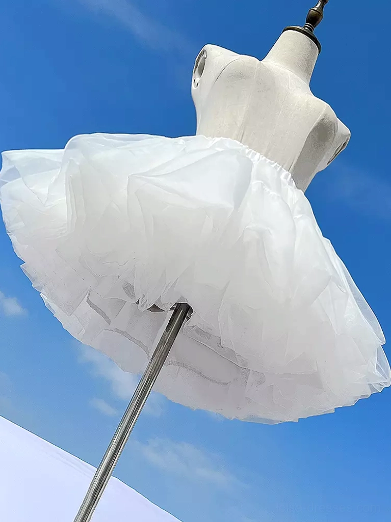 White lolita petticoat low angle side view on dress mannequin showing voluminous bell-shaped tulle skirt structure with metal support pole against sky background demonstrating authentic lolita silhouette