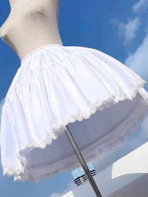 Close-up side view of white lolita petticoat showing elastic waistband, soft pleated polyester fabric texture, and intricate lace hemline detail on dress form