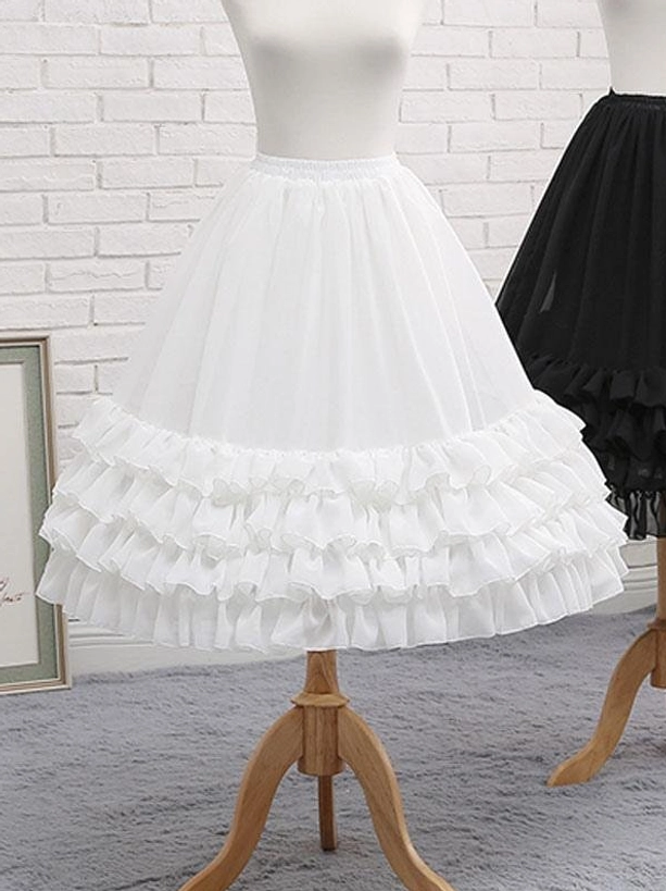 White lolita petticoat front side angle view ruffle layers brick wall background dimensional silhouette