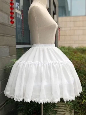 White lolita petticoat side view showing layered puffy ruffled construction and lace hem trim on mannequin in outdoor street setting with buildings and greenery