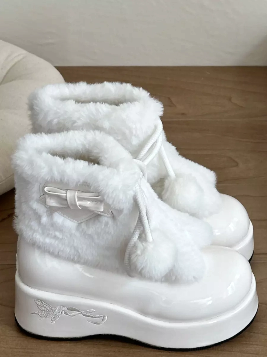 White lolita platform boots rear angle showing patent leather sole and pom-pom drawstring details