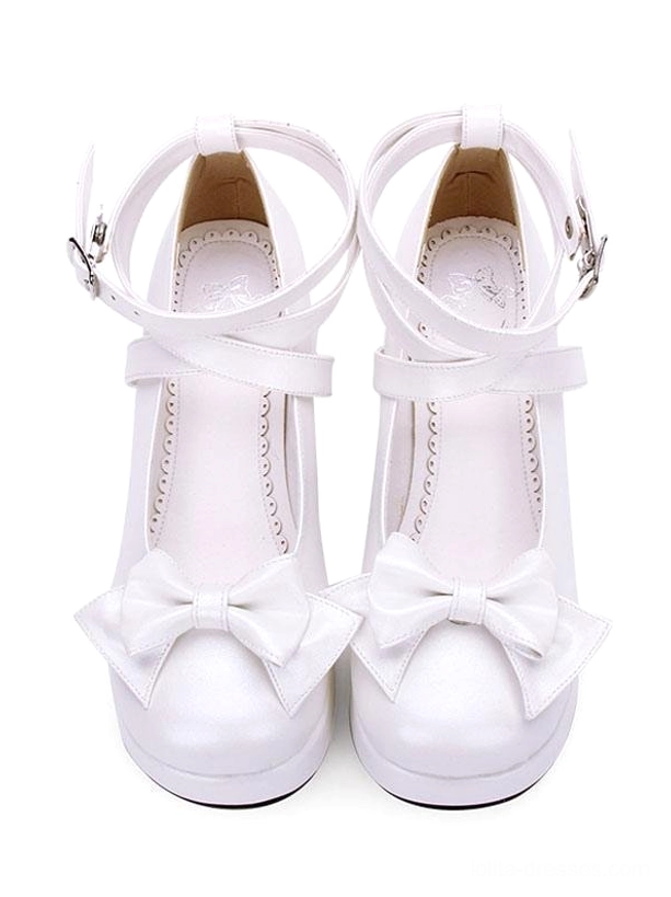 All-white Sweet Lolita platform pumps with front bow and single cross ankle strap overhead front view on pure white background, platform sole detail visible