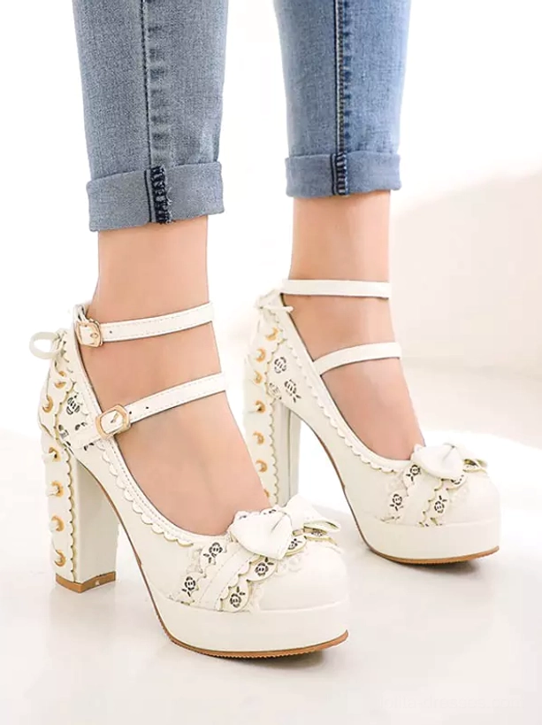White lolita platform pumps front view with rolled blue jeans, featuring perforated block heel, double ankle straps, bow toe and platform sole