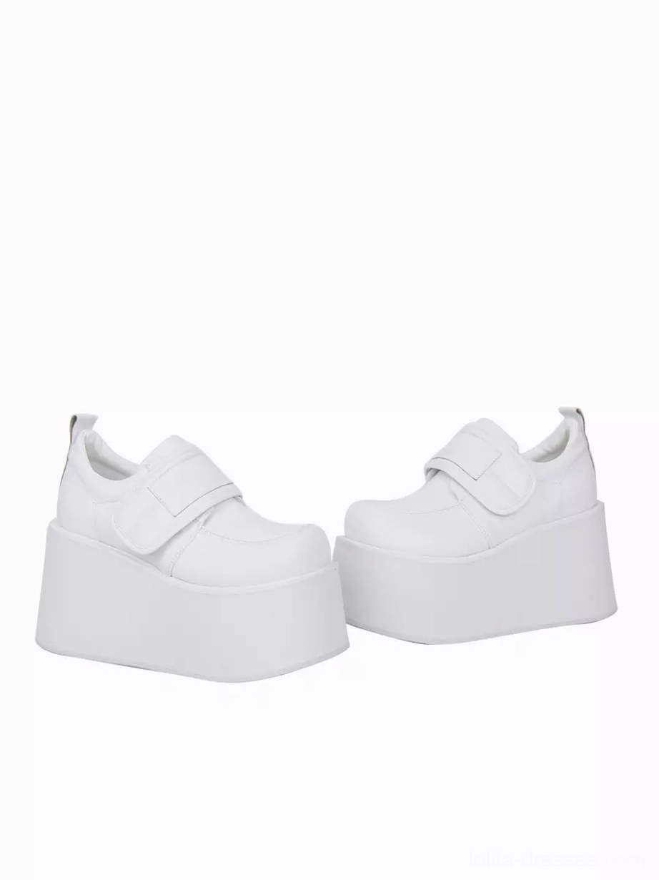 Pair of white lolita platform pumps low front side view compact round toe matte PU upper substantial platform wedge heel construction