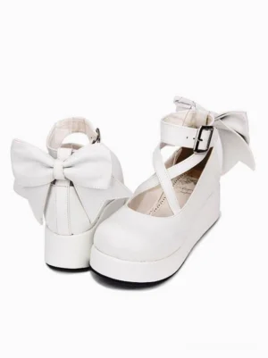 White Lolita platform wedge shoes featuring rear bow decoration and ankle strap system, three-quarter front angle