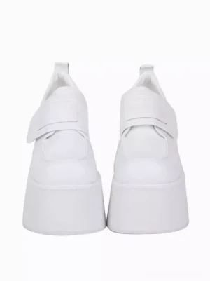 White lolita platform pumps direct front view displaying hook-and-loop fastening strap tall platform sole heel pull tab round toe silhouette