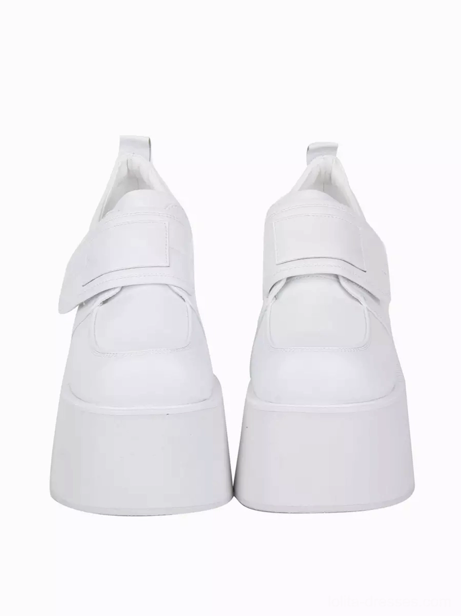 White lolita platform pumps direct front view displaying hook-and-loop fastening strap tall platform sole heel pull tab round toe silhouette