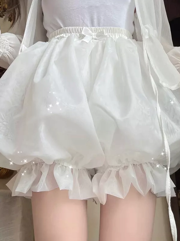 Front view of white lolita pumpkin bloomer safety shorts with delicate ruffled hem and elastic waist bow detail on indoor model