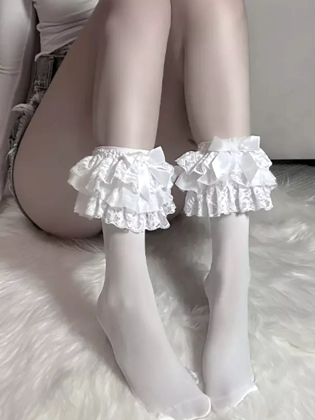 White lolita socks with double-layer lace ruffle and satin bow worn with denim shorts, side angle view on fluffy white rug demonstrating mid-calf coverage and romantic lolita styling