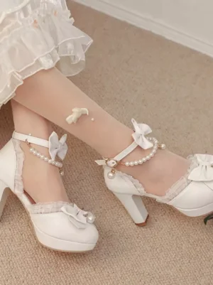 Side view of white lolita heeled sandals featuring ruffled edges pearl ankle chain and platform block heel with model wearing sheer stockings