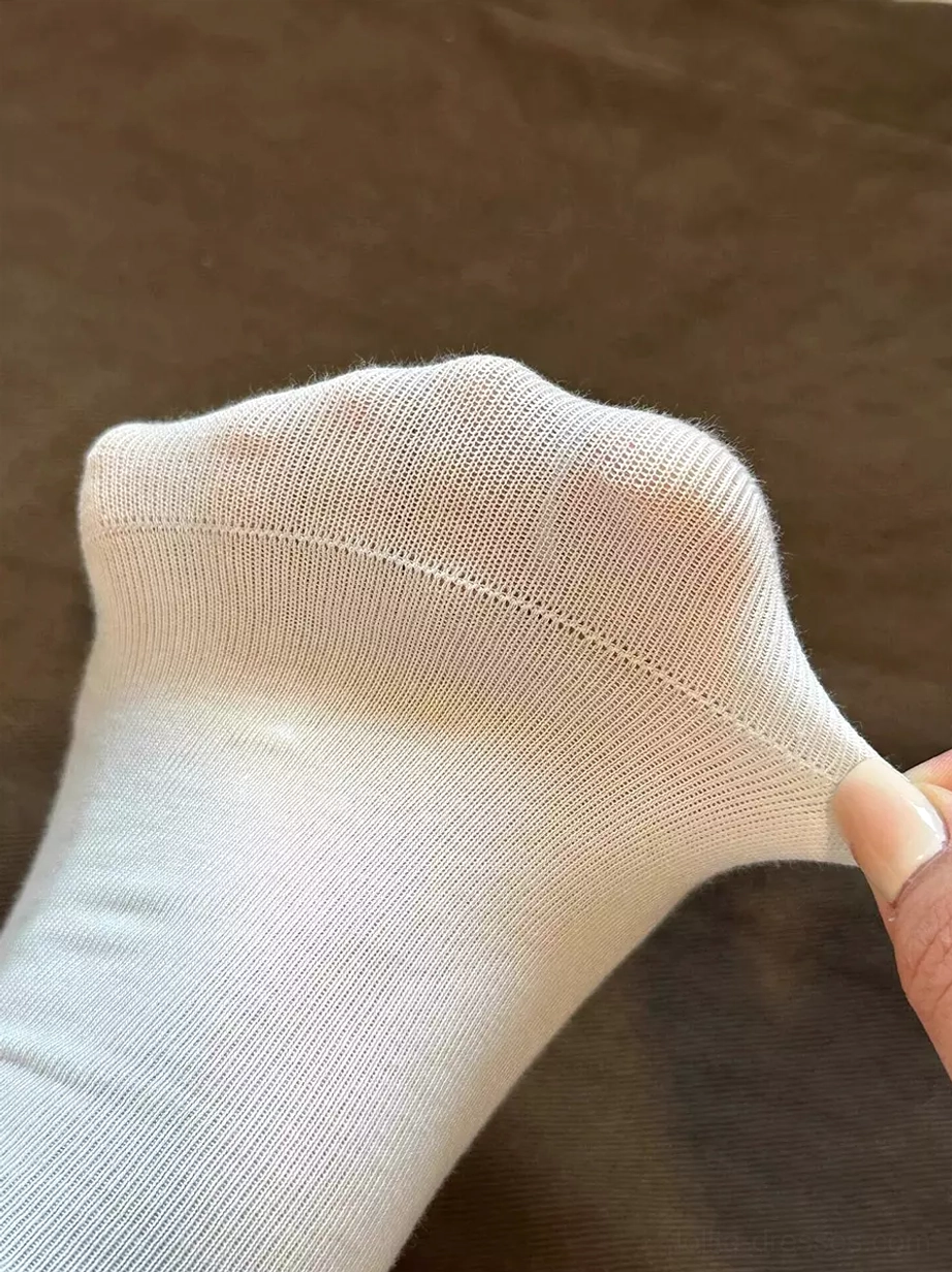 Stretchy white lolita sock showing soft knit texture and ribbed cuff stretch quality, kawaii hosiery comfort material composition