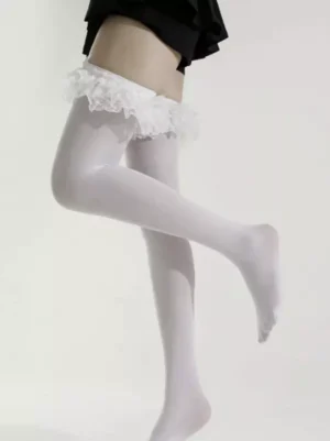 White lolita over-the-knee socks with layered ruffled lace cuff, side low angle view showcasing sock length and texture against black pleated skirt