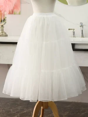 White lolita tiered petticoat underskirt rear quarter view on dress form showing multi-layered sheer tulle ruffles and elastic waistband