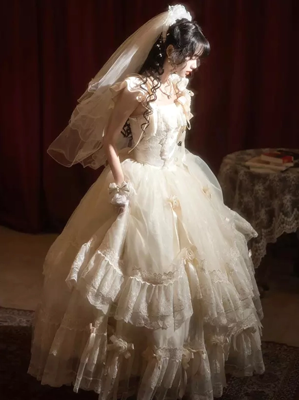 White Classic Lolita dress back view showcasing voluminous tiered tulle and full lace trim details, worn with wedding veil in romantic vintage interior
