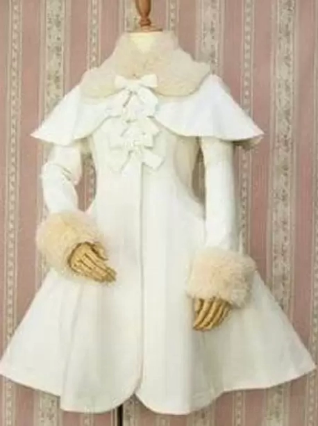 White Lolita winter coat with beige fur collar and detachable cape, front view showcasing bow embellishments and tailored waistline