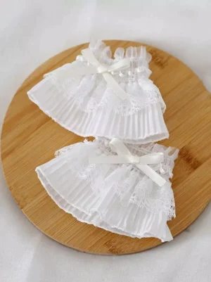 pair-of-white-lolita-oversleeves-wrist-cuffs-flat-lay-lace-frills-layered-ruffles-satin-bow