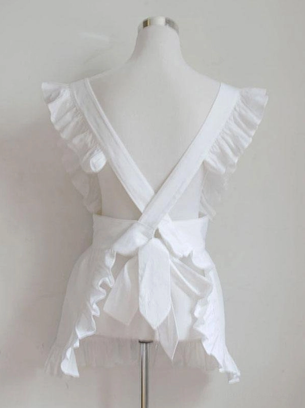 White maid lolita apron back view showing crisscross straps and decorative bow with ruffled trim details