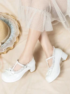 White Mary Jane lolita pumps with T-strap buckle and bow toe, top-side wearing perspective with block platform heel and dotted tulle skirt