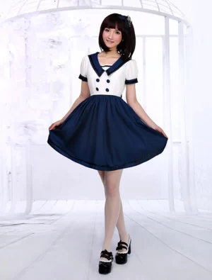 White navy sailor lolita short sleeve dress front full body view with classic two-tone design, flared A-line skirt, and sailor collar on female model in white studio with birdcage background