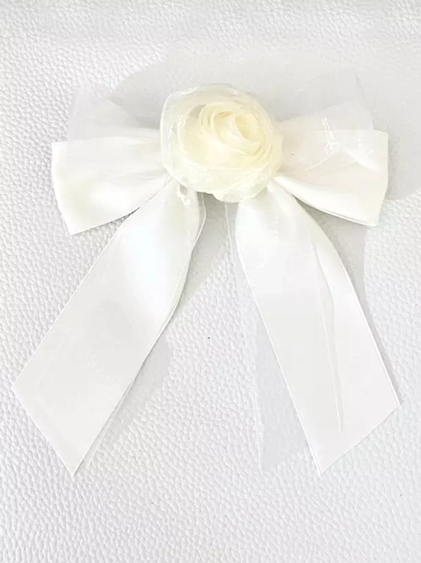 Pure white sheer organza bow hair clip with cream rose embellishment, flat lay front view on white textured background, elegant sweet lolita hair accessory