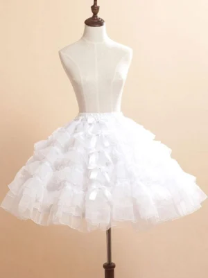 White organza lolita skirt front full-body view on dress form with tiered ruffled layers and dual satin bow decorations