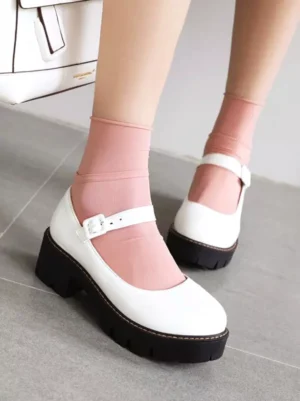 White patent leather Mary Jane platform pumps with adjustable ankle strap and black lug platform sole, front on-foot display for Lolita fashion styling