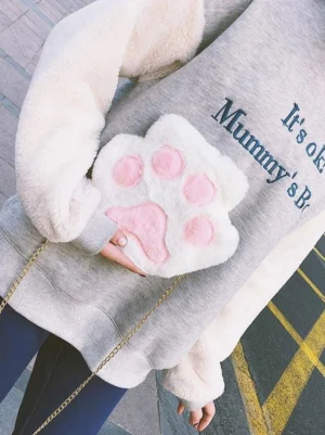 White and pink cat paw plush lolita shoulder bag with gold chain strap, worn crossbody style, rear angle close-up showing fluffy faux fur texture and adorable paw pad details
