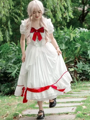 White plaid classic lolita OP dress with red ribbon chest bow front view garden setting