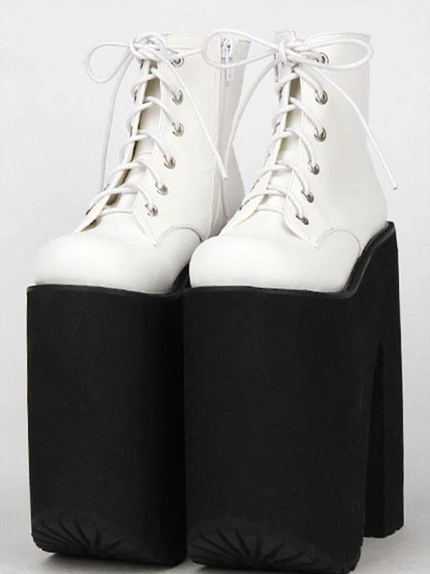 White platform short boots front flat lay view white leather upper black thick platform heel metal lace holes glossy finish