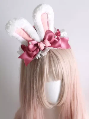 White plush bunny ear lolita headband with rose pink satin bow and pearl accents front view on mannequin with pastel pink wig sweet lolita fashion accessory