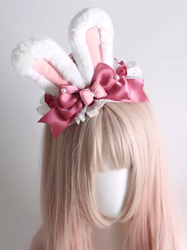 White plush bunny ear lolita headband with rose pink satin bow and pearl accents front view on mannequin with pastel pink wig sweet lolita fashion accessory
