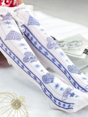 White poker print knee-high lolita socks with blue card motifs and ruffled lace cuff, styled on model's legs with cute table decorations